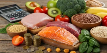 Vibrant healthy food spread with financial elements, symbolizing savings.